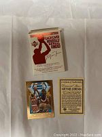 Photos showing both sides of two Michael Jordan limited edition 24kt gold cards, the certificate of authenticity, and original packaging box.