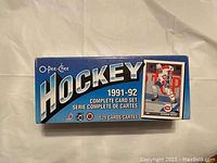 Closed factory box of 1991-92 O-Pee-Chee hockey card set showing the front with product title and card image.