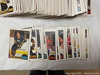 Front view of hockey cards showing players in action from various NHL teams including Sabres and Canucks.