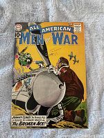 Front cover of All American Men of War #87 comic book showing military pilot with plane and bomb.