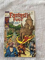 Front cover of Fantastic Four comic book issue #84 showing main characters and villain Doctor Doom in front of a castle.