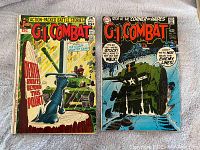 Front covers of GI Combat Comic Books #139 and #151 placed side by side on a plain surface, showing their vintage war-themed cover art and titles.