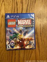 Front cover of LEGO Marvel Super Heroes game for PS4 showing LEGO Marvel characters in action.