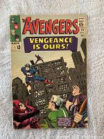 Front cover of The Avengers comic book issue #20 with title and artwork featuring superheroes, Captain America flying above two characters with cityscape background.