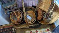 View of several woven baskets of varying sizes along with small rustic wooden chair