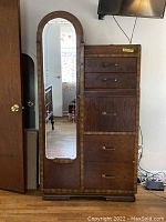 Front view of the antique dresser showing the arched mirror on the left and four drawers stacked vertically on the right with a pull-down secretary drawer.