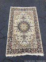 First rug runner with floral medallion design on asphalt surface.