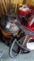 Shop-Vac Ultra Plus wet/dry vacuum showing top and brand label, capacity of 10 gallons and 4 peak horsepower noted on unit.