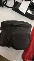 Black leather camera case for Miranda camera with front pouch visible.