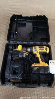 Open plastic case showing DeWalt cordless drill, battery, and charger inside.