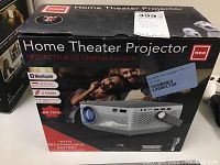 Box showing RCA home theater projector branding and key features such as Bluetooth, rechargeable battery, HD 720p resolution, and HDMI inputs.