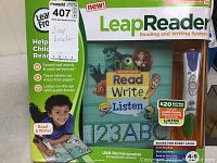 Box showing LeapReader Reading and Writing System packaging with main branding and activity book title Read Write Listen.