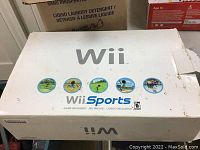 Original white Nintendo Wii console box featuring Wii Sports game artwork.