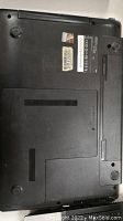 Bottom view of Samsung NP309ESC laptop showing labels and vents