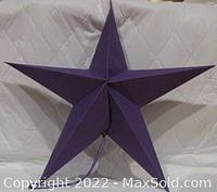 Dark purple large paper star measuring 24" point to point, displayed on a quilted background showing fold and construction details.