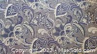 Close-up of the paisley and flower pattern upholstery fabric highlighting the detailed design and color scheme.
