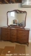 Full front view of dresser and attached mirror in room