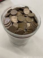 Clear plastic container holding over 1,800 Wheat pennies