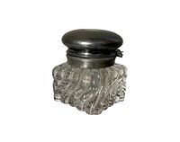 Front angle view of antique glass inkwell with pewter lid showing swirl glass pattern and rounded pewter lid