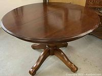 Front view of assembled round table top and pedestal base
