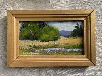 Frontal photo of the miniature framed painting showing a landscape scene with trees, pond, and distant mountains. Signed by the artist.