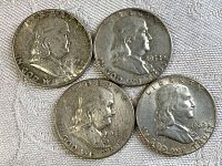 Obverse side of 4 Franklin half dollar coins dated 1949, 1952, 1955, and 1962R showing Benjamin Franklin portrait and inscriptions.
