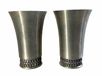 Front view of both pewter Mastad Norway cups showing the tapered flared body and decorative diamond pattern near base.
