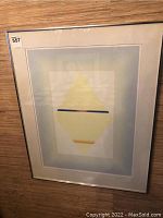 Full view of framed art print hung on wall