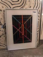 Framed print with white mat leaning against wall