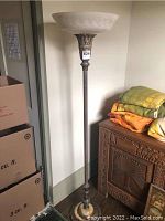 Full view of the vintage torchiere floor lamp standing approximately 62.5 inches tall, showing the slender metal column and the glass shade on top