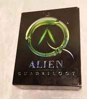 Front cover of the Alien Quadrilogy box showing the stylized green xenomorph forming a circle and the title 'Alien Quadrilogy'.