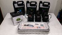 Overall view of all items including three nutrient containers, seed starter, herb planter, hydroponic jars with net cups
