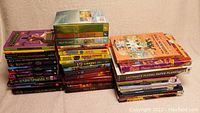 Front view of stacked fiction and non-fiction books for young teens in good condition.