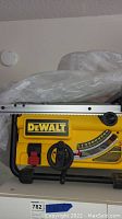 Front view showing DeWalt logo, bevel gauge and fence rail.