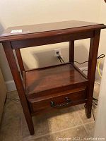 Front and angled view of pier one wood end table with drawer and middle shelf.