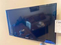 Front view of Samsung TV showing screen and bezel with brand name.