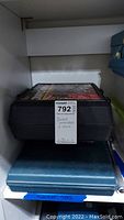 Two black plastic cases stacked on a shelf, top labeled 'socket wrench + more' (Power Kraft set)