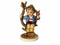 Front angle view of Hummel Apple Tree figurine #142, showing seated boy on tree branch holding apples