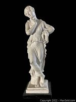 Front view of G Ruggeri The Dancer statue showing detailed draped classical attire and pose on black base.