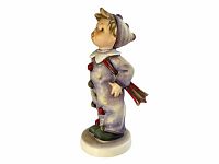 Side view of the Hummel Carnival #328 figurine showcasing the posture, detailed costume, and umbrella held behind the back.