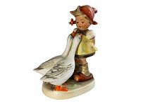 Front and side view of the Goose Girl figurine with two geese. Shows details of the figure's clothing and geese painting.