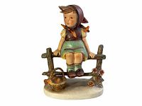 Front view of Hummel porcelain figurine Just Resting #112 showing the girl sitting on a fence with basket and flowers.