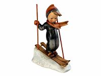 Side view of Hummel Skier Figurine showing the arms, ski poles, skis and snow base, highlighting the painted details and condition