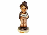 Photo of Hummel figurine Street Singer showing full front view with visible chip on base.