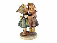 Porcelain Hummel figurine 'Telling Her Secret' model #196 shown from the front with detail of two children, one whispering to the other.