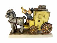 Side view of the porcelain figurine showing the mail coach, driver blowing horn, and two spotted horses mounted on the base.