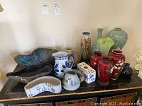 Overhead shot of all vases, pitchers and planters on black lacquer table