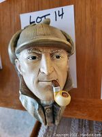 Close-up image of Bosson chalkware Sherlock Holmes head sculpture with pipe and deerstalker cap.