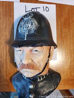 Front view of Bosson chalkware head statue showing officer with black helmet, badge, and uniform collar marked 171.