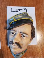 Close-up image of the Bosson chalkware head showing detailed face and cap.